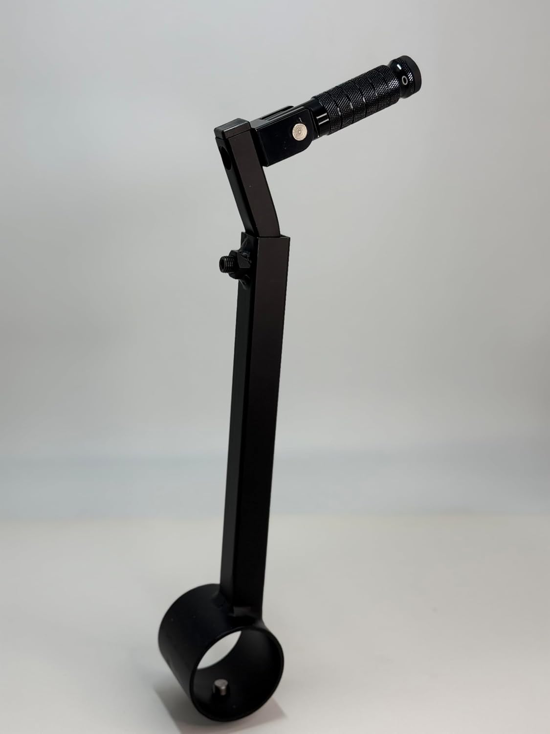 The black Potter's Peg pottery wheel attachment, a black powder coated peg with a knurled grip mounted on an adjustable leg clamp