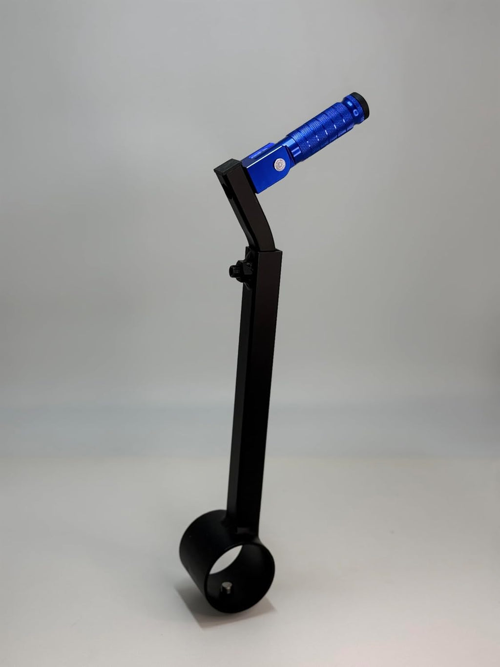 The blue Potter's Peg pottery wheel attachment, a black powder coated peg with a knurled grip mounted on an adjustable leg clamp