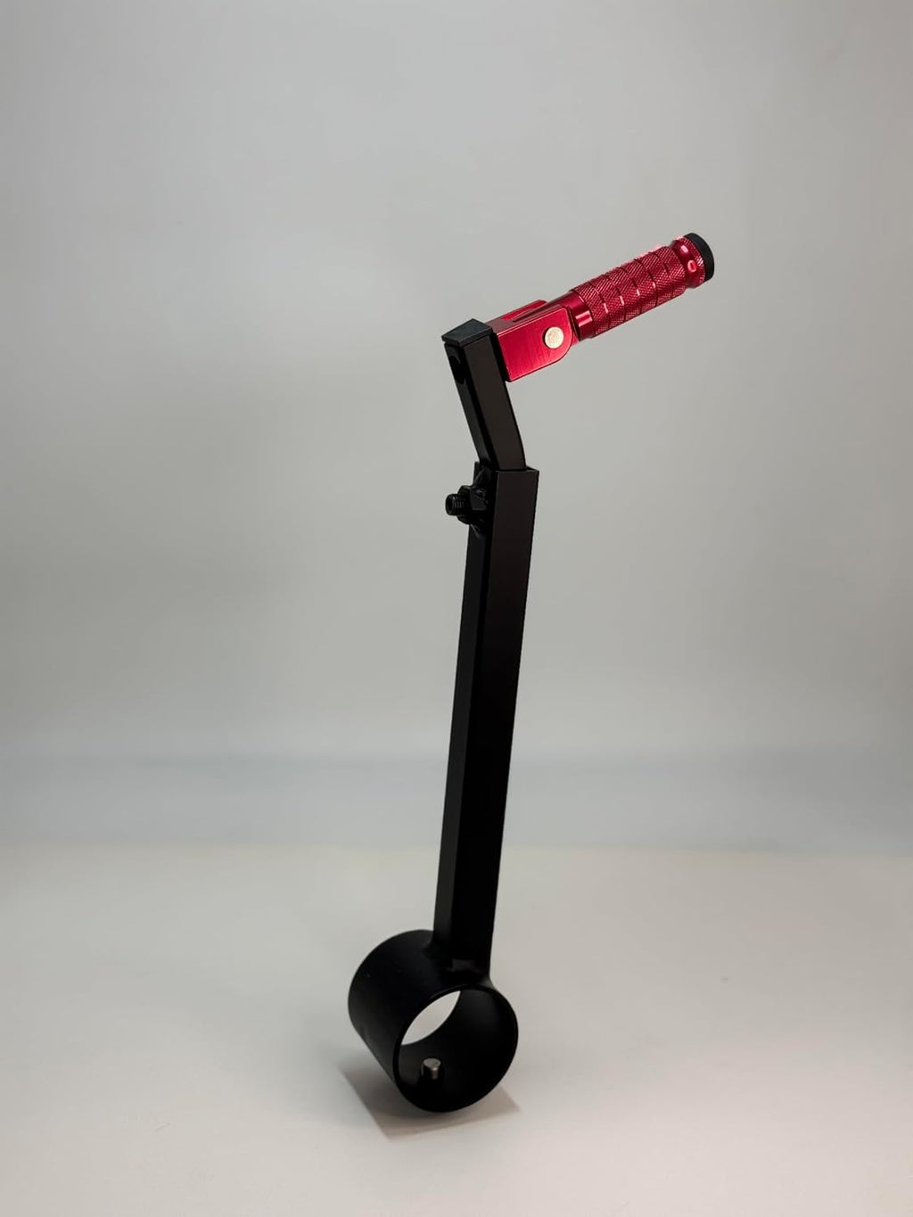 The red Potter's Peg pottery wheel attachment, a black powder coated peg with a knurled grip mounted on an adjustable leg clamp