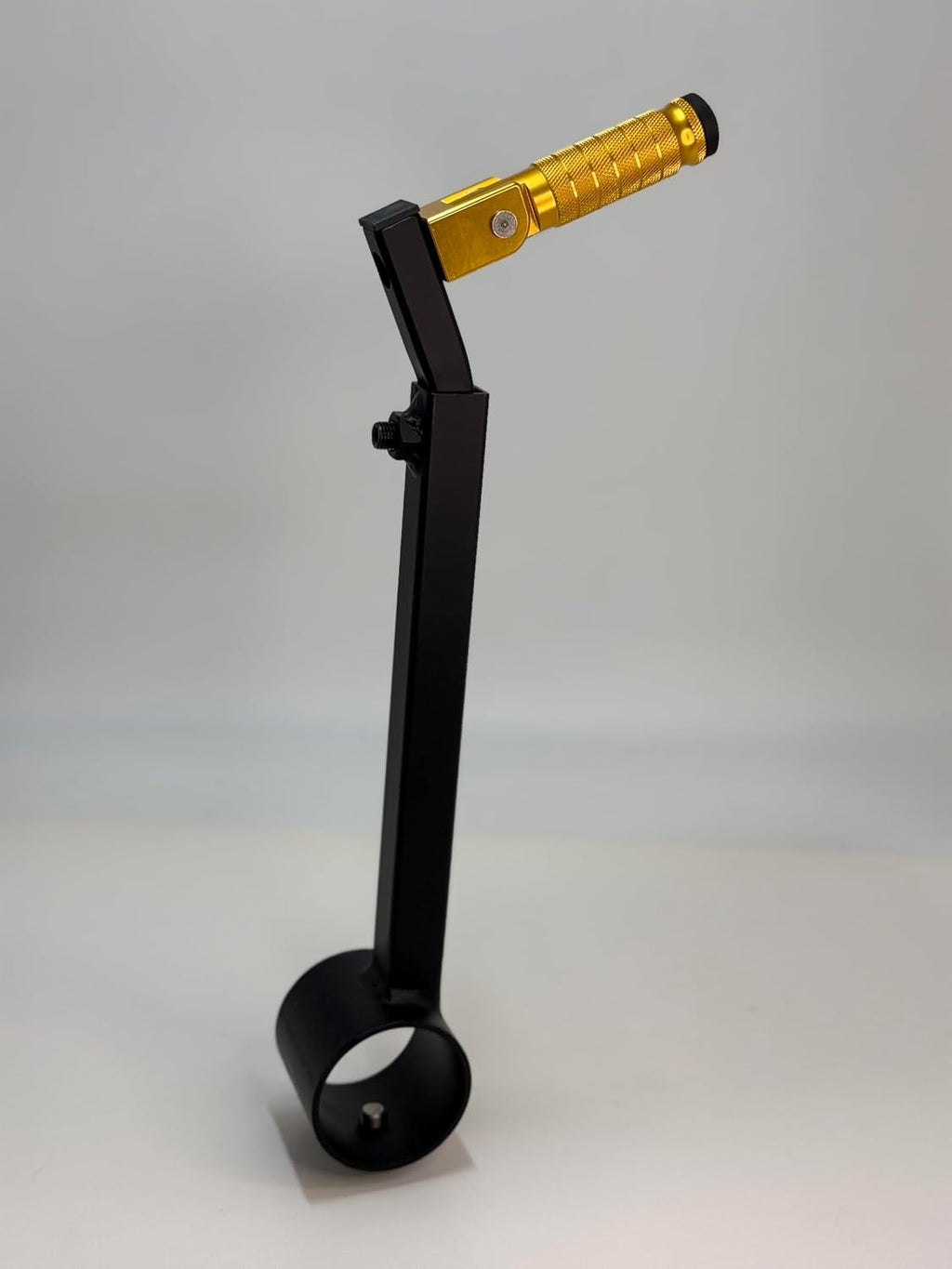 The yellow Potter's Peg pottery wheel attachment, a black powder coated peg with a knurled grip mounted on an adjustable leg clamp